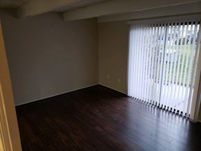 Columbus triplex for rent - an empty living room with wood floors and a large window