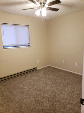 Columbus triplex for rent - an empty room with a window and a ceiling fan