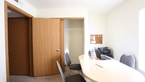 Columbus apartment for rent - A conference room with a table, chairs, and a printer.