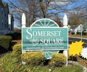 Columbus apartment for rent - A sign for Somerset Square Apartments & Condominiums is displayed in front of a building.