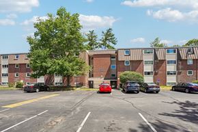Seabrook apartment for rent - A parking lot with cars and apartment buildings in the background.