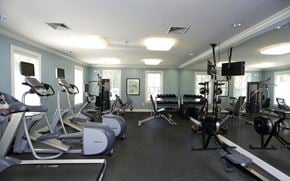 Hooksett apartment for rent - a gym with weights and cardio equipment in a home gym