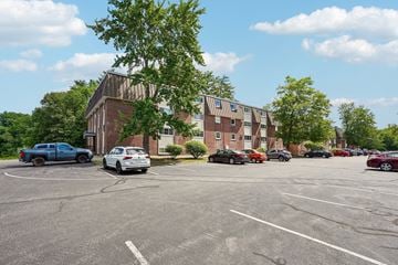 Seabrook apartment for rent - A parking lot with cars and a building in the background.