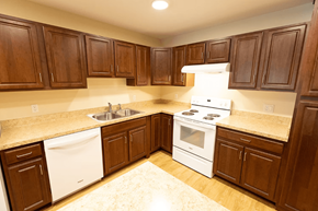 Salem apartment for rent - A kitchen with white appliances and brown cabinets.