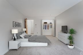 Leominster apartment for rent - A bedroom with a bed, nightstand, and a plant.