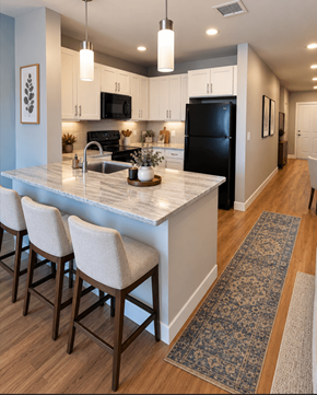 Fitchburg apartment for rent - A kitchen with a black fridge and white cabinets.