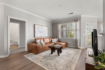 Woburn apartment for rent - A living room with a brown leather couch and a coffee table.