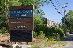 Seabrook apartment for rent - A sign for Rockingham Village Apartments sits in front of a building.
