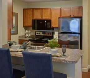 Hooksett apartment for rent - a kitchen with granite counter tops and stainless steel appliances