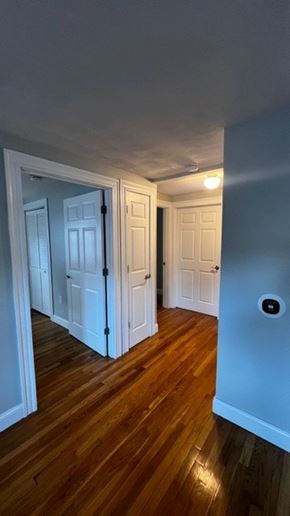 Quincy apartment for rent - A hallway with two doors and a wood floor.