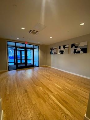 Fitchburg apartment for rent - A room with wooden flooring and a large window with a view of a city.