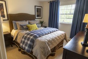Derry apartment for rent - a bedroom with a bed and a dresser and a window