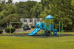 Summerville townhouse for rent - A playground with a blue slide and a green structure.