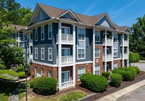 Durham apartment for rent - A large apartment building with multiple balconies and a brick facade.