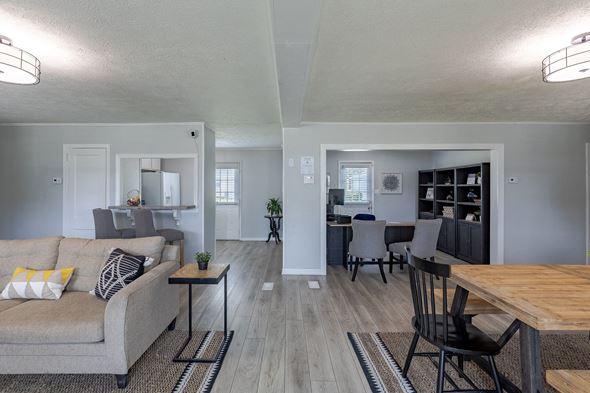 Fayetteville apartment for rent - A living room with a grey couch and a wooden table.