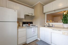 Fayetteville apartment for rent - A white refrigerator is in a kitchen with white cabinets.