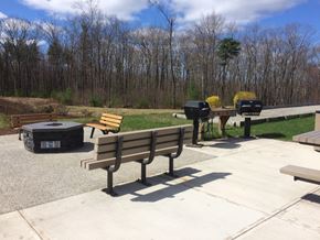 Hooksett apartment for rent - a picnic area with benches and a grill
