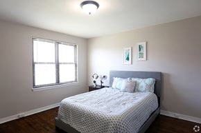 Collingswood apartment for rent - A bedroom with a bed, nightstand, and window.
