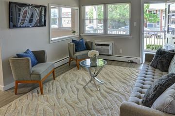 Allentown apartment for rent - A living room with a grey couch, a coffee table, and a painting on the wall.