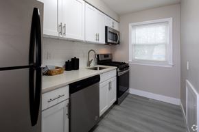 Allentown apartment for rent - A kitchen with black appliances and white cabinets.