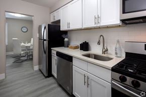 Allentown apartment for rent - A kitchen with white cabinets and a black refrigerator.