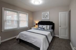 Allentown apartment for rent - A bedroom with a bed, nightstand, and window.