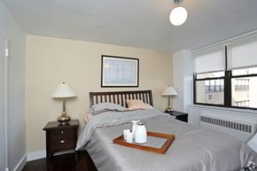 Philadelphia apartment for rent - A bedroom with a bed, nightstand, and window.