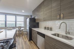 Philadelphia apartment for rent - A modern kitchen with a black refrigerator and stove top oven.