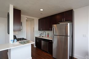 Philadelphia apartment for rent - A kitchen with a stainless steel refrigerator and wooden cabinets.