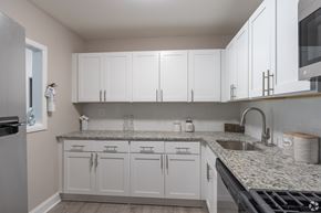 Glassboro apartment for rent - A kitchen with white cabinets and granite countertops.