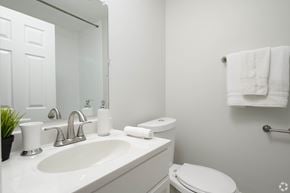 Glenolden apartment for rent - A white bathroom with a toilet, sink, and towel rack.