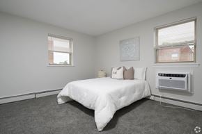 Glenolden apartment for rent - A bedroom with a bed, window, and air conditioner.