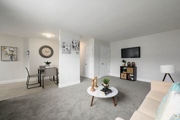 Glenolden apartment for rent - A living room with a grey carpet and a white wall.