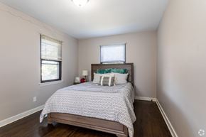 Pitman apartment for rent - A bedroom with a bed, nightstand, and window.