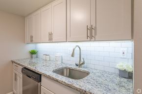 Newark apartment for rent - A kitchen with a granite countertop and a stainless steel sink.