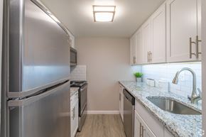 Newark apartment for rent - A kitchen with a stainless steel refrigerator and a granite countertop.