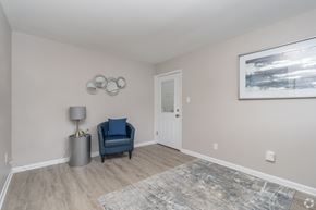 Pottstown apartment for rent - A room with a blue chair and a grey floor lamp.