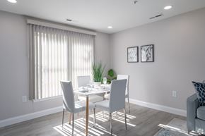 Allentown apartment for rent - A dining room with a table set for two and a potted plant on the windowsill.