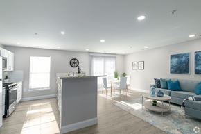 Allentown apartment for rent - A modern kitchen with a large island and a dining area with a sofa.