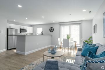 Allentown apartment for rent - A modern living room with a grey sofa and a wooden coffee table.
