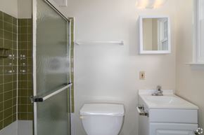Bethlehem apartment for rent - A white toilet sits next to a white sink in a bathroom.