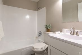 Bensalem apartment for rent - A white toilet sits next to a white sink in a small bathroom.