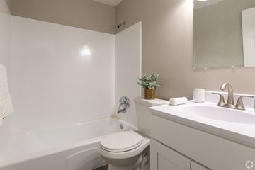 Bensalem apartment for rent - A white toilet sits next to a white sink in a small bathroom.