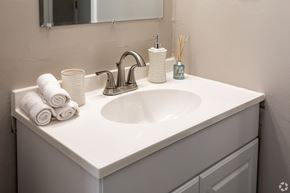 Newark apartment for rent - A white bathroom sink with a silver faucet and towels.
