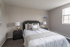 Newark apartment for rent - A bedroom with a large bed and two nightstands with lamps.
