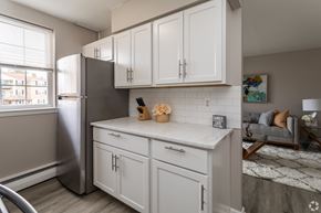 Newark apartment for rent - A kitchen with white cabinets and a stainless steel refrigerator.