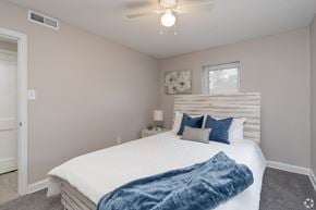Allentown apartment for rent - A bedroom with a bed, pillows, and a ceiling fan.