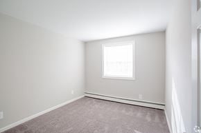 Barrington apartment for rent - A room with a window and carpeted floor.