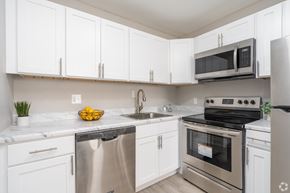 Barrington apartment for rent - A kitchen with white cabinets and stainless steel appliances.