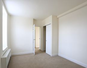 Philadelphia apartment for rent - A white room with a carpet floor and a window on the left side.